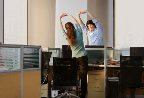 getty_rf_photo_of_office_workers_doing_stretches_at_night.jpg