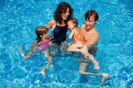 11212511-Happy-family-with-kids-in-swimming-pool-Smiling-parents-and-children-on-summer-vacation-Stock-Photo.jpg